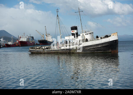 Ushuaia, Argentina - April 2 2019: An old British ship of the 2nd world war run aground and abandoned in front to the city. Stock Photo