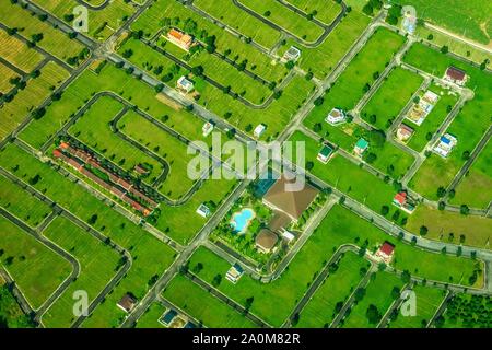 Aerial view of a new housing subdivision in the Philippines with empty lots and new buildings. Urban expansion and property development in Asia. Stock Photo