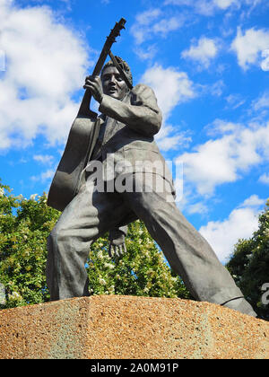 MEMPHIS, TENNESEE - JULY 23, 2019: A bronze statue of Elvis Presley playing his guitar, erected by scuptor Andrea Lugar in 1997, depicts the musician Stock Photo