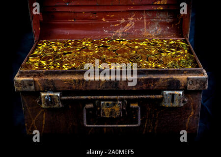 Stacking Gold Coin in treasure chest  on black background Stock Photo