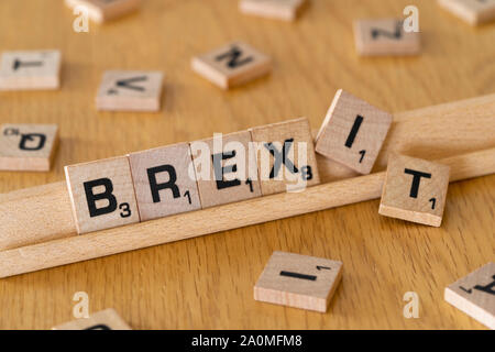 Wooden scrabble letters on a rack spelling out the word Brexit Stock Photo