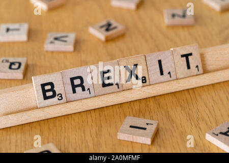 Wooden scrabble letters on a rack spelling out the word Brexit Stock Photo