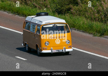 1972 70s Yellow Volkswagen Westfalia; UK Vehicular traffic, transport, recreational  cars, high top roof, pop top roofs, pop top, caddy, Transporter, camper vans, kombi, combi, campervan vans, motorhome, auto sleeper conversion, Vee Dub, conversions, microbus, bus, campers, drop roof, Volkswagen motorhomes, auto sleeper south-bound on the 3 lane M6 motorway highway, Lancaster, UK Stock Photo