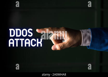 Handwriting text writing Ddos Attack. Conceptual photo perpetrator seeks to make network resource unavailable Isolated hand pointing with finger. Busi Stock Photo