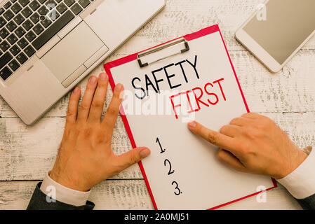 Writing note showing Safety First. Business concept for Avoid any unnecessary risk Live Safely Be Careful Pay attention Stock Photo