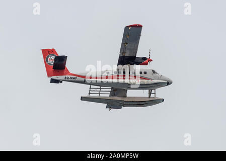 Male, Maldives - November 16, 2017: Maldivian Air Taxi airplane De Havilland Canada DHC-6-300 Twin Otter of the Trans Maldivian Airways flying in clou Stock Photo