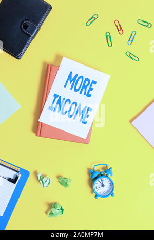 Text sign showing More Income. Business photo showcasing Additional money receives for an exchange of good or services Pile of empty papers with copy Stock Photo