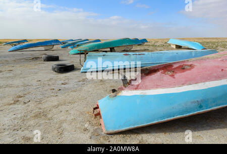 Small boats laying on the retreated shore of the almost disappeared Aral Sea near Aralsk, Kazakhstan. Stock Photo