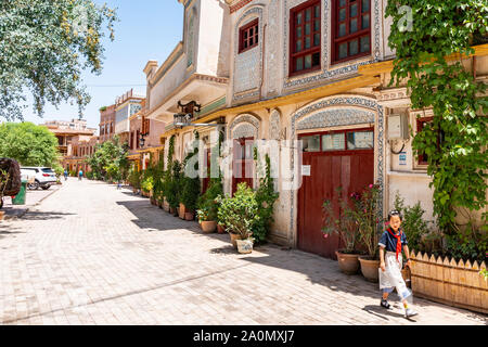 Kashgar Renovated Old City Uyghur School Girl is Walking down the Street on a Sunny Blue Sky Day Stock Photo