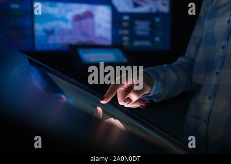 Woman using multimedia touchscreen display of interactive kiosk Stock Photo