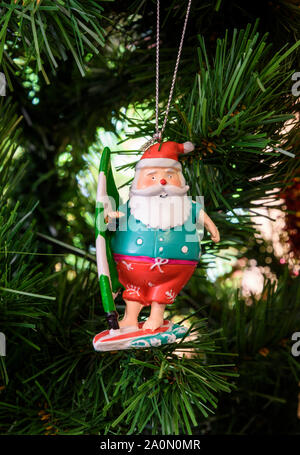 Australian Father Christmas decoration hanging on a Christmas tree in Australia Stock Photo