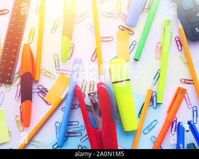 stationery stapler, paper clips, notes, pens and pencils on the table Stock Photo