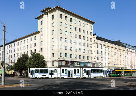 Advert covered tram turning from Runeberginkatu to Mannerheimintie in Töölö district of Helsinki, Finland Stock Photo