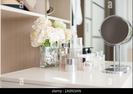 Set of cosmetic cream packaging, lotion bottle and skincare product on dressing table Stock Photo