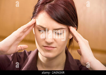 Woman with a headache – stress, depression, young women Stock Photo