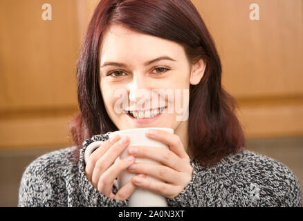 Young woman drinking coffee Stock Photo
