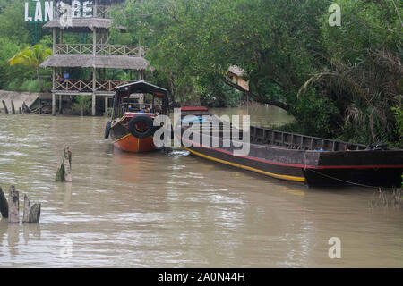 JULY 18, 2019-MEKONG DELTA, VIETNAM : Mekong Delta river in Vietnam where boats are parked along the shore. Stock Photo