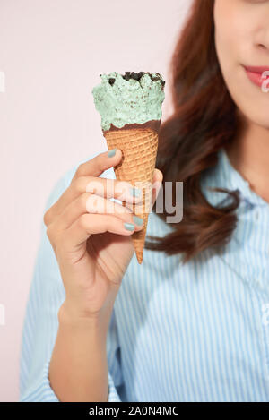 Sweet happy moments of attractive fashionable young woman having fun with cone ice cream on pink background. Dreaming, delicious, enjoying, happiness, Stock Photo