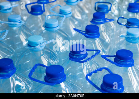 Empty plastic bottles in a rows. Plastic pollution Stock Photo