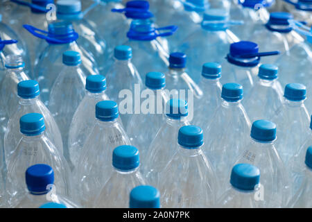 Empty plastic bottles in a rows. Plastic pollution Stock Photo
