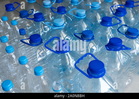 Empty plastic bottles in a rows. Plastic pollution Stock Photo
