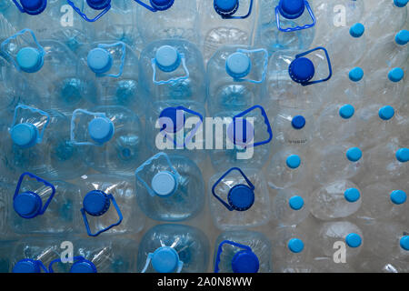 Empty plastic bottles in a rows. Plastic pollution Stock Photo