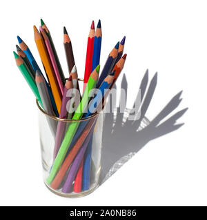 Different colors pencils for drawing in a glass on a white background Stock Photo
