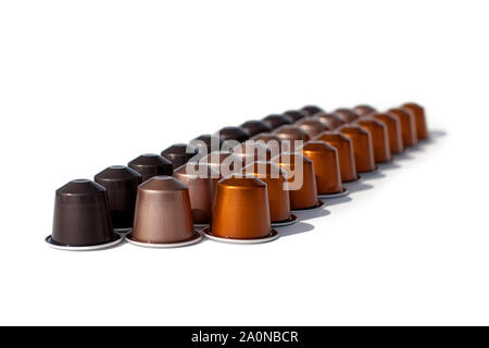 Coffee capsules different kinds and colors on a white background isolated in three lines closeup macro Stock Photo