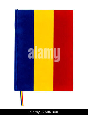 Blue, yellow, and red tricolor notebook representing Romanian flag isolated on white. Stock Photo