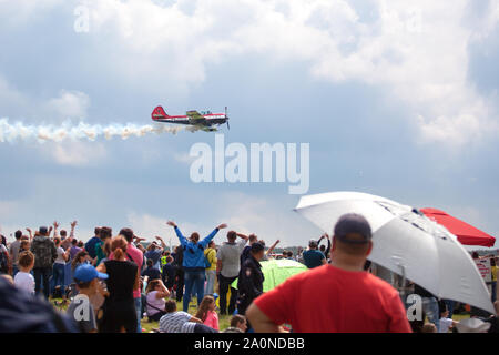 Novosibirsk, Russia, July 31, 2016, Mochishche airfield, local air show, yak 52 on blue sky with clouds background and people watching aviashow Stock Photo