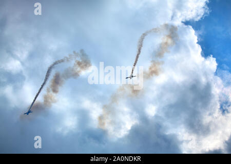 Novosibirsk, Russia, July 31, 2016, Mochishche airfield, local air show, two Yak-52, aerobatics The Bell, aerobatic team 'Open Sky', Barnaul Stock Photo