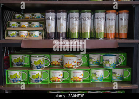 JULY 18, 2019-Ho Chi Minh City Vietnam : Mugs and tumblers with prints representing Vietnam stacked on a shelf sold in Starbucks located in Vietnam. Stock Photo