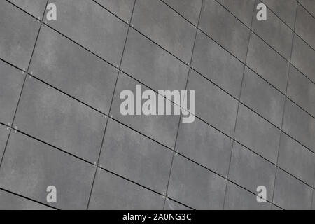 Angle view of modern just placed gray ceramic tiles with dark joint. Backdrop, texture or pattern for design Stock Photo