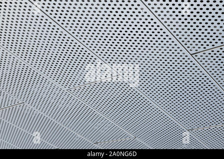 Metal grilles with many round holes in the ceiling. Stock Photo