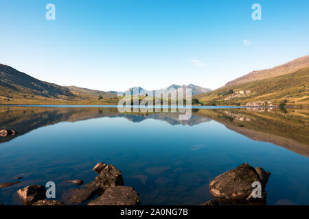 Llynnau Mymbyr are two joined lakes located in Dyffryn Mymbyr valley in Snowdonia and here seen with Mount Snowdon in the background. Stock Photo