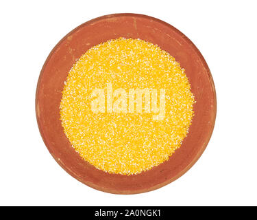 Food texture background of maize flour, top view in terracotta red plate. Stock Photo