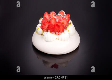 Strawberry Pavlova cake on a black mirror background isolated Stock Photo