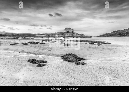 The ruins of the 13th century Eileen Tioram [The dry island] castle in the western Highland of Loch Moidart and River Shiel in monochrome Stock Photo