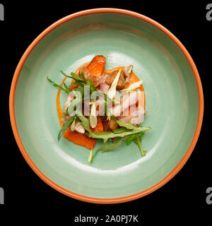 Game bird fillet with sweet potato mash and mushrooms in green porcelain plate, isolated on black background Stock Photo