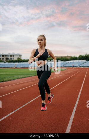 Female runner jogging, training on stadium Stock Photo