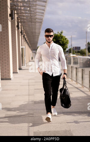 Businessman or lawyer in formal suit with briefcase goes in centrelink offices of company or in the building of state authority. Stock Photo