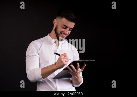 Business man and a folder. Signing some documents. Being happy about the profits. Stock Photo