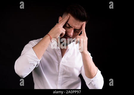 a young man suffering from headache. handsome caucasian man. Stock Photo