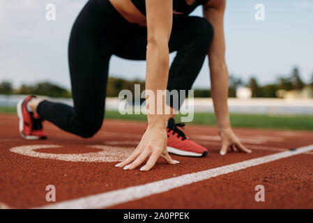 Female runner on start line, training on stadium Stock Photo