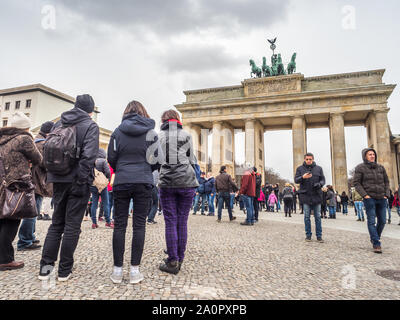 Berlin, Germany - March 16, 2019: A lot of tourist before the Brandenburg Gate, viewed from the Pariser Platz on the East side Stock Photo