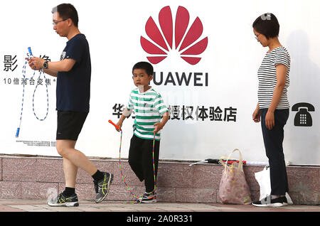 Beijing, China. 21st Sep, 2019. A Chinese family walks past a Huawei store in Beijing on Saturday, September 21, 2019. Huawei is offering up its most valuable 5G secrets and close to $1.5 billion to software developers, attracting the global tech community at a time the U.S. is increasing scrutiny of the Chinese giant. Photo by Stephen Shaver/UPI Credit: UPI/Alamy Live News Stock Photo