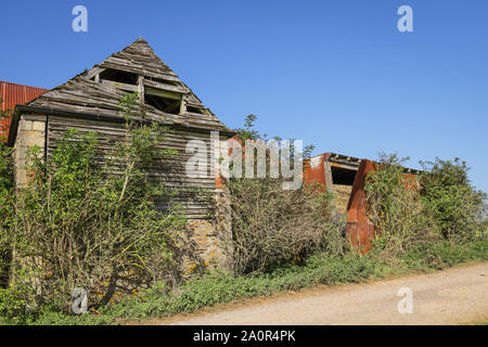 Dilapidated, run down wood and rusty metal farm buildings Stock Photo