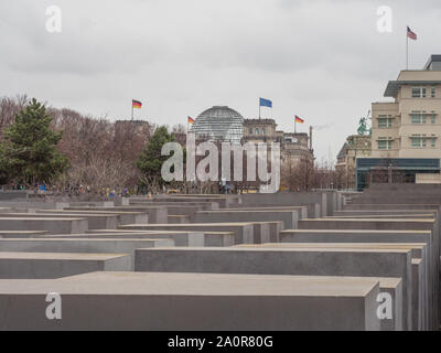 Berlin, Germany - March 16, 2019: The Holocaost monument in Berlin, Germany with glass dome of Reichstag in the back Stock Photo