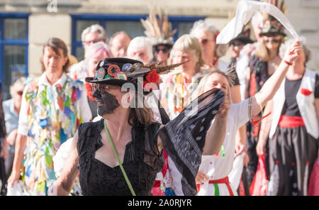 Stroud, UK. 21st September 2019. Stroud, a Cotswold town hosts its annual Folk weekend. Morris dancers from around the Cotswolds and Forest of Dean prance around the town entertaining the shoppers, ending with a grand gathering in the square. Morris Dancing is a traditional English pastime, once associated with begging in the 15th to 18th centuries. Begging was illegal at the time; so blackface was adopted as a disguise. The group is Styx of Stroud. Credit: Mr Standfast/Alamy Live News Stock Photo