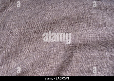 Crumpled textile texture as a background. Natural fabric linen texture for design. Close up Stock Photo